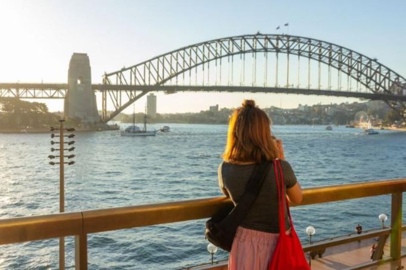 young person looking at view of a bridge